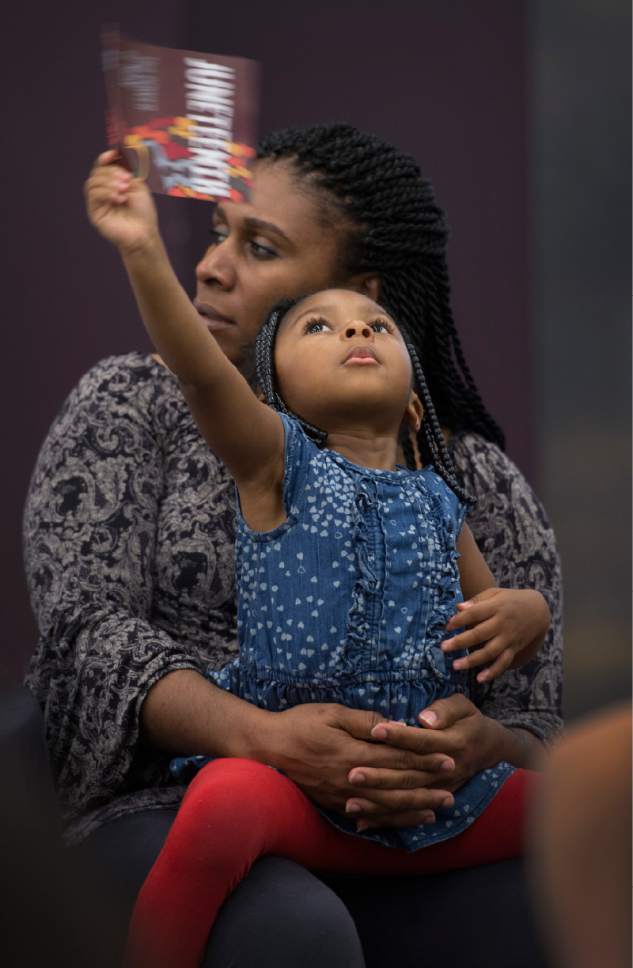 Leah Hogsten  |  The Salt Lake Tribune
Shenita Pittman and her daughter Emery, 3, listen as attendees of the "The State of Black Utah" town hall share ideas for improving quality of life, community relations and economic development in Utah's African American community. Pittman just moved to Utah in January from Georgia and wanted to learn about the health of the African American community. The town hall is part of the 28th annual Juneteenth Freedom and Heritage Festival, which celebrates the end of slavery in the United States.