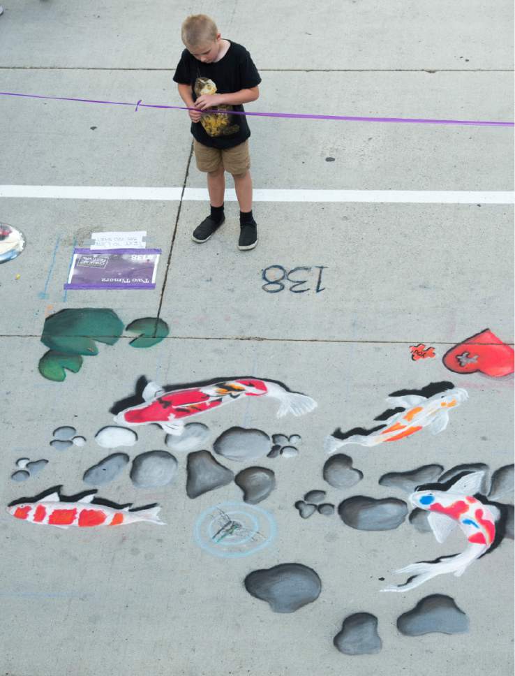Rick Egan  |  The Salt Lake Tribune

A chalk art drawing by Two Timerz on Rio Grande Street at the Gateway, during the Utah Foster Care Chalk Art Festival, Saturday, June 17, 2017.