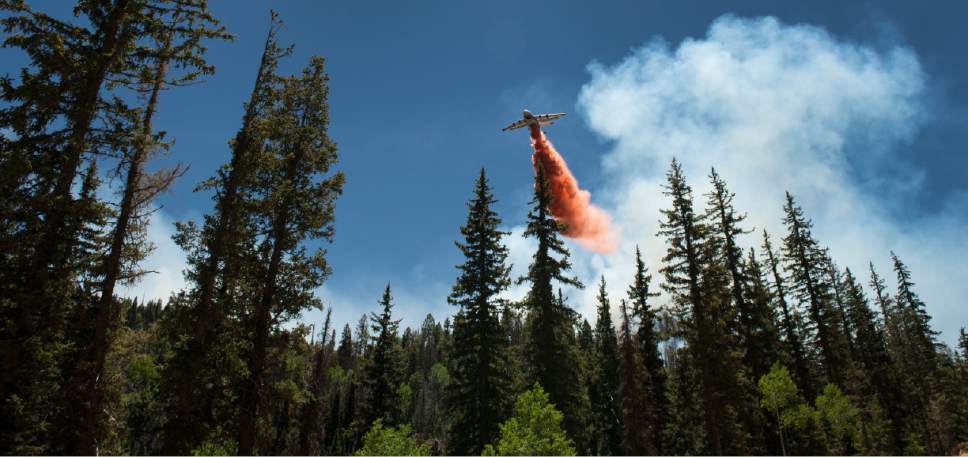 Leah Hogsten  |  The Salt Lake Tribune
Planes dropped fire retardants on the fire, Sunday, June 18, 2017 along State Route 143. A wildfire that forced hundreds to evacuate from the southern Utah ski town of Brian Head burns along State Route 143, the primary road to the town.  The slope driven fire, which is burning on private land, is zero percent contained and estimated to change Sunday afternoon as conditions grow hotter, drier and winds pick up.