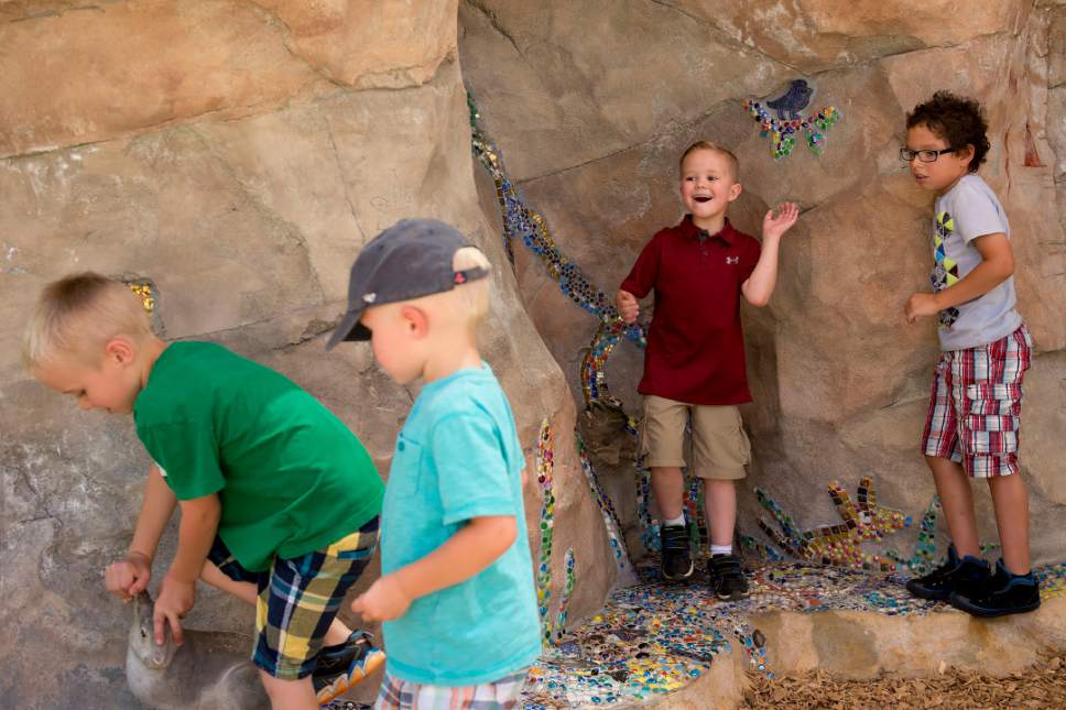 Madeline Huntsman  |  The Salt Lake Tribune


Children play at the Hogle Zoo's new sensory wall on Friday, June 16, 2017. Artist Roger Whiting designed the wall with help from children who have special needs.