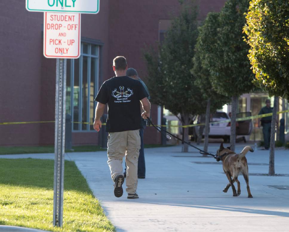 Rick Egan  |  The Salt Lake Tribune

A police dog checks out the school grounds at Eagle Valley Elementary School in Eagle Mountain. The school was evacuated after a masked man entered the school on Monday, Sept. 19, 2016.