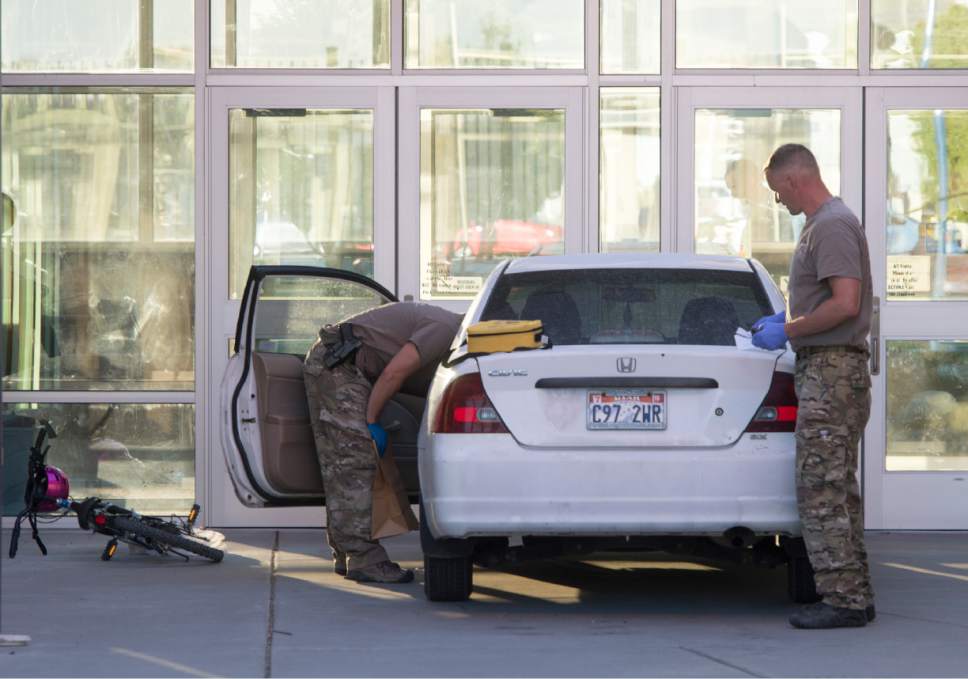 Rick Egan  |  The Salt Lake Tribune
Police check out the suspect's car at Eagle Valley Elementary School in Eagle Mountain in September. The school was evacuated after a masked man entered the school and claimed the car contained explosives.