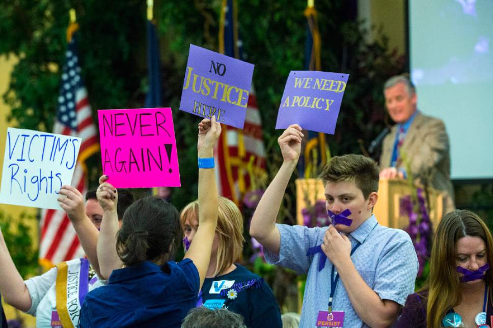 Chris Detrick  |  The Salt Lake Tribune
Protestors hold up signs and demonstrate as Chairman Peter Corroon speaks during the Utah State Democratic Party 2017 State Organizing Convention at Weber State University Shepard Union Saturday, June 17, 2017. They were protesting against the Democratic Party's response to the allegations against Rob Miller.