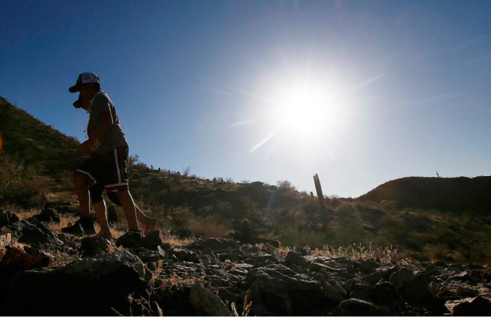 Hikers brave the afternoon sun as the temperatures hit 110-degrees Thursday, June 15, 2017, in Phoenix. Temperatures are expected to climb to 120-degrees in the metro area in the next week. (AP Photo/Ross D. Franklin)