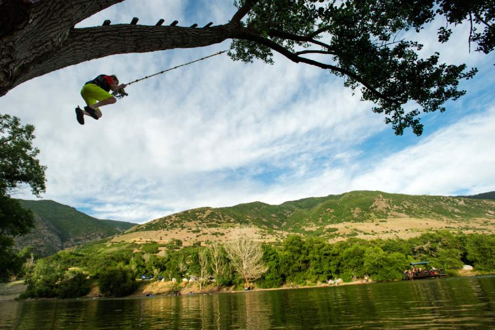 Rick Egan  |  The Salt Lake Tribune

Matthew Cannon, 13, Farmington, swings on a ropes swing into Farmington pond, Monday, June 19, 2017.