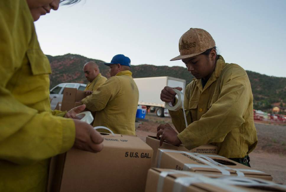 Leah Hogsten  |  The Salt Lake Tribune
South Piute Agency firefighter Duke Fox prepares water boxes for drinking and other supplies to assist firefighters on the fire line at the Iron County Fairgrounds in Parawan, Monday, June 19, 2017, to put out a wildfire burning north of the southern Utah ski town of Brian Head.