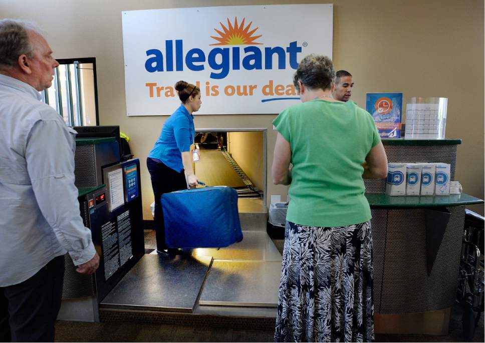 Scott Sommerdorf   |  The Salt Lake Tribune  
Allegiant  workers take baggage from passengers for a flight out of Provo Wednesday afternoon, August 31, 2016.