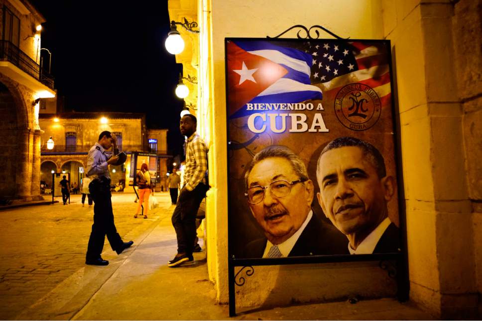 A poster features portraits of Cuba's President Raul Castro, left, and U.S. President Barack Obama and reads in Spanish "Welcome to Cuba" outside a restaurant in Havana, Cuba, Thursday, March 17, 2016. Obama is scheduled to travel to the island on March 20, the first U.S. presidential trip to Havana in nearly 90 years. (AP Photo/Ramon Espinosa)