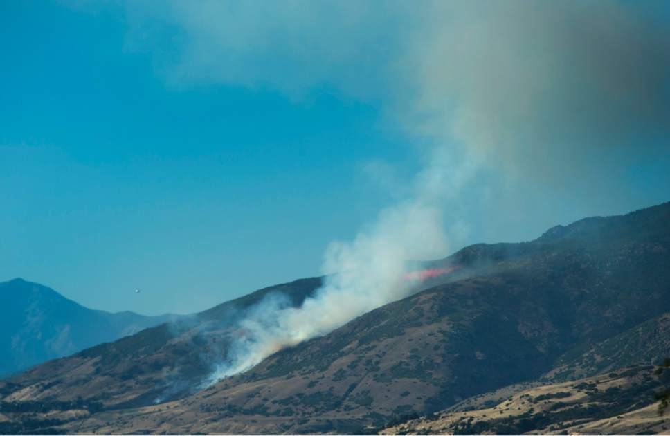 Rick Egan  |   Tribune file photo
A fire burns on the mountain near Farmington on Friday.