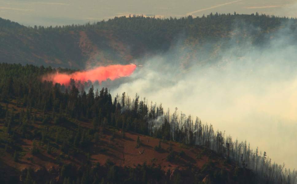 Rick Egan  |  The Salt Lake Tribune

A plane drop fire retardant on the Brian Head fire, as it continues to burn north of the southern Utah ski town of Brian Head, Wednesday, June 21, 2017.