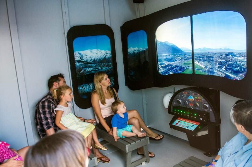 Chris Detrick  |  The Salt Lake Tribune
Visitors look at the flight simulator in the Intermountain Life Flight Rescue Hangar at the Discovery Gateway Children's Museum Saturday, June 24, 2017. The Intermountain Life Flight Rescue Hangar lets children discover the supporting roles of a rescue team and includes flight simulation experiences to rescue an injured hiker or snowboarder, a hoist activity with two missions to secure and transport and injured hiker or snowboarder to Primary Children's Hospital, and a mechanic's shed activity.
