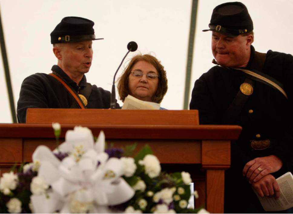 Trent Nelson  |  Tribune file photo
Terry Fancher, left, Patty Norris, and Phil Bolinger, descendants of Mountain Meadows Massacre survivors, read the names of the dead during a  commemoration at the massacre site on Saturday, May 30, 2009.