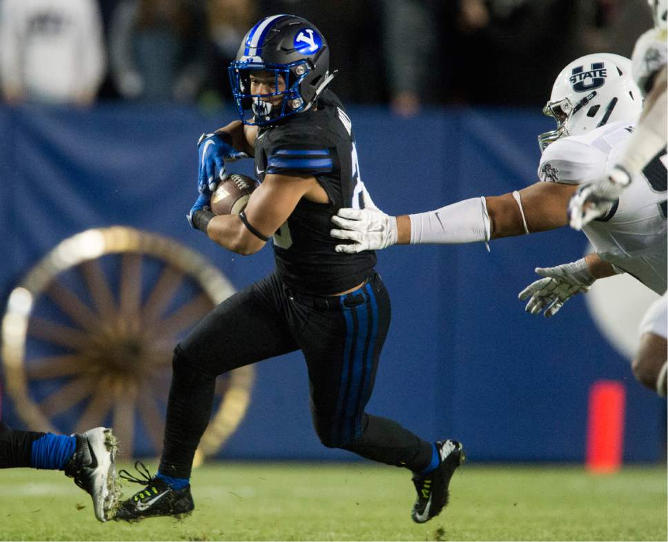 Rick Egan  |  The Salt Lake Tribune

Brigham Young Cougars running back Squally Canada (22) runs the ball for the Cougars, in football action, BYU vs Utah State, at Lavell Edwards Stadium in Provo,  Saturday, November 26, 2016.