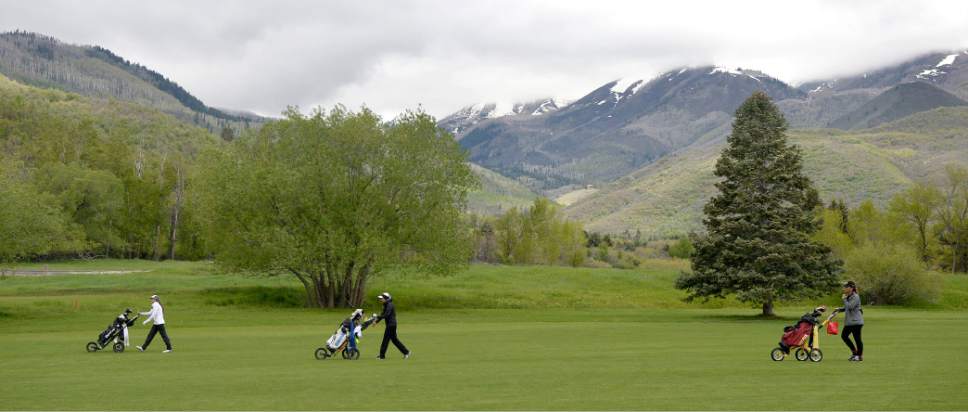Al Hartmann  |  The Salt Lake Tribune
Top 5A threesome, Davis High School's Laura Gerner, left, Binham's Tess Blair and Lone Peak's Masina Kaohelaulii wlak the front nine on the stormy final day of the of the 5A girls' golf tournament on the Lake Course at Wasatch Mountain State Park Monday May 17.