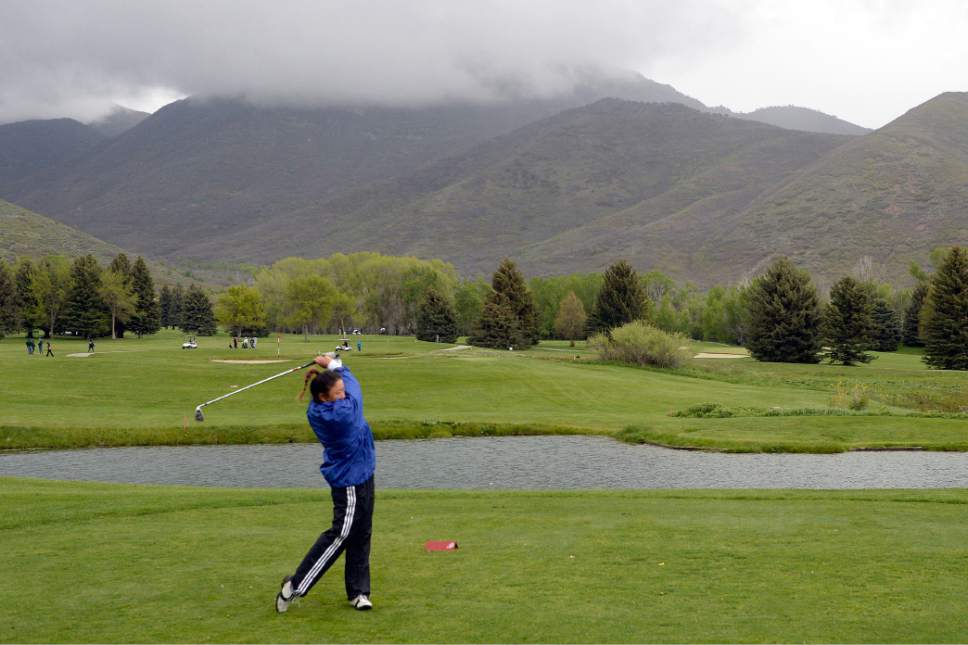 Al Hartmann  |  The Salt Lake Tribune
Skyline's Rebekah Moon drives in the rain on the first day of the of the 4A girls' golf tournament on the Lake Course at Wasatch Mountain State Park Monday May 16.