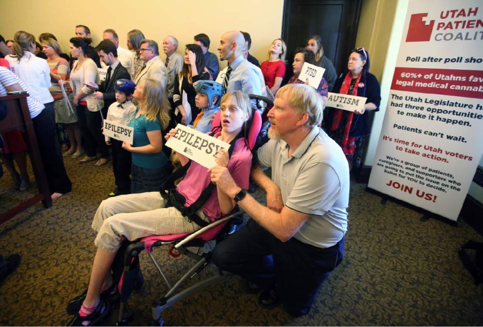 Rick Bowmer  |  AP Photo


Doug Rice, right, and his daughter Ashley, left, look on with other patients, caregivers and supporters during the Utah Patients Coalition news conference at the Utah State Capitol Monday, June 26, 2017, in Salt Lake City. A group of activists and Utah residents with chronic conditions has launched a ballot initiative to ask voters next year to pass a broad medical marijuana law.