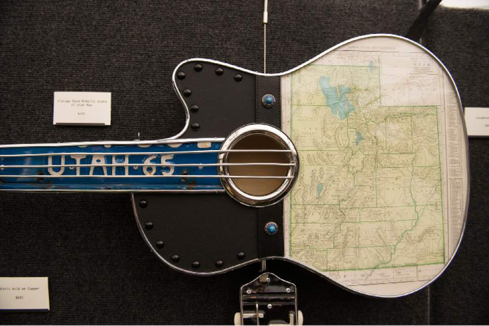 Leah Hogsten  |  The Salt Lake Tribune
Todd Perkins' Vintage Rand-McNally State of Utah Map guitar at his Utah Arts Festival booth (#12), June 22, 2017.  Perkins creates unique guitar art from up-cycled materials to create one of a kind, themed custom art.   The Utah Arts Festival is the largest outdoor multi-disciplinary arts event in Utah, running through June 25, 2017 at the City and County Building grounds in downtown Salt Lake City.