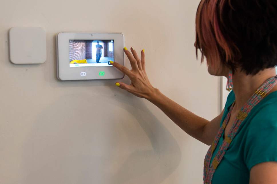 Chris Detrick  |  The Salt Lake Tribune
James and Aleisha McDaniel's demonstrate the doorbell camera on the SkyControl Panel in their Vivint Smart Home in South Jordan Thursday, June 8, 2017.