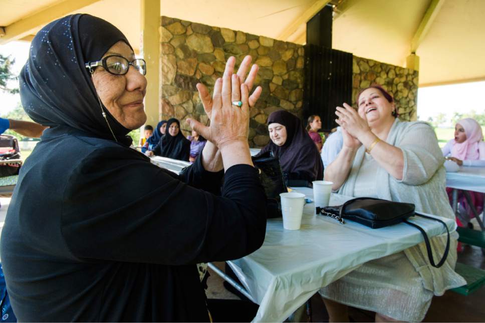 Rick Egan  |  The Salt Lake Tribune


Khawla Salman and Suzan Binyamin sing and clap to a Middle Eastern song played by Bazeen. Women of the World hosted an Eid Mubarak to celebrate the end of Ramadan at Sugar House Park on Monday, June 26, 2017.