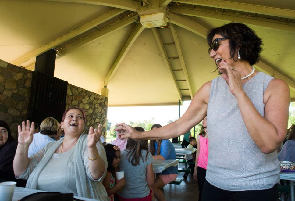 Rick Egan  |  The Salt Lake Tribune


Suzan Binyamin and Samira Harnish dance to Middle Eastern music played by Bazeen on Monday, June 26, 2017. Women of the World hosted an Eid Mubarak to celebrate the end of Ramadan at Sugar House Park.