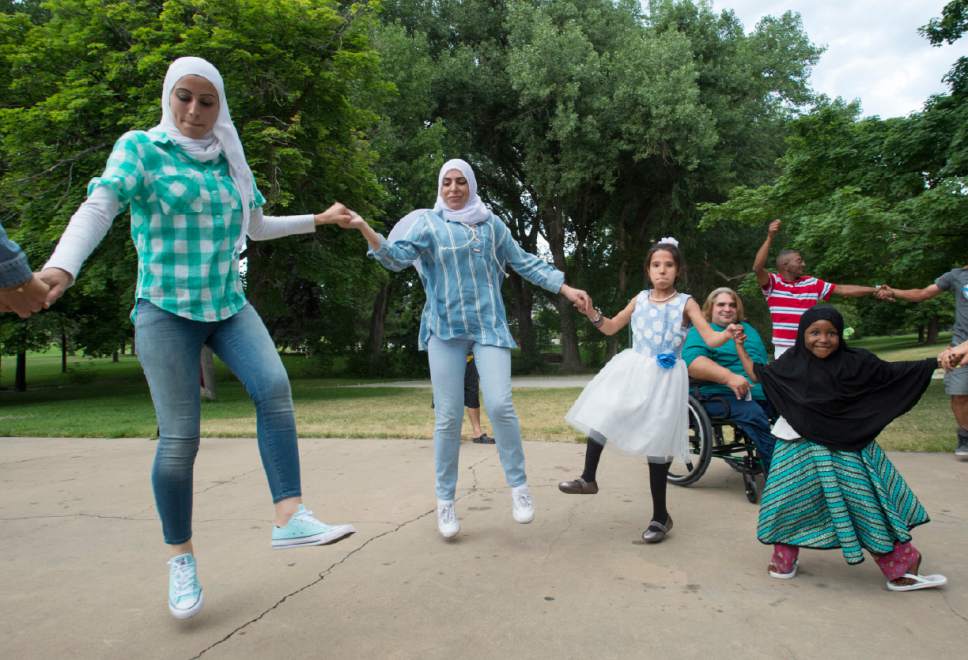 Rick Egan  |  The Salt Lake Tribune


Participants dance at the Eid Mubarak to celebrate the end of Ramadan. The event was hosted by Women of the World at Sugar House Park on Monday, June 26, 2017.