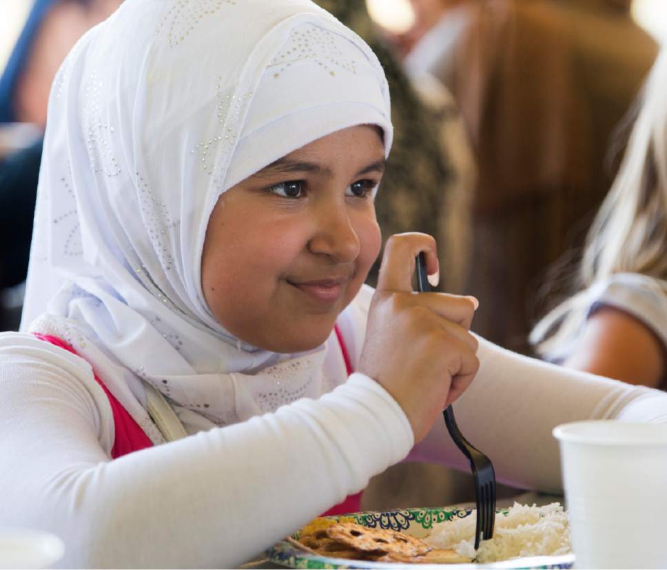 Rick Egan  |  The Salt Lake Tribune


Beneen Al-Saedy, 9, enjoys the food at the Eid Mubarak to mark the end of Ramadan. The dinner was hosted by Women of the World at Sugar House Park on Monday, June 26, 2017.
