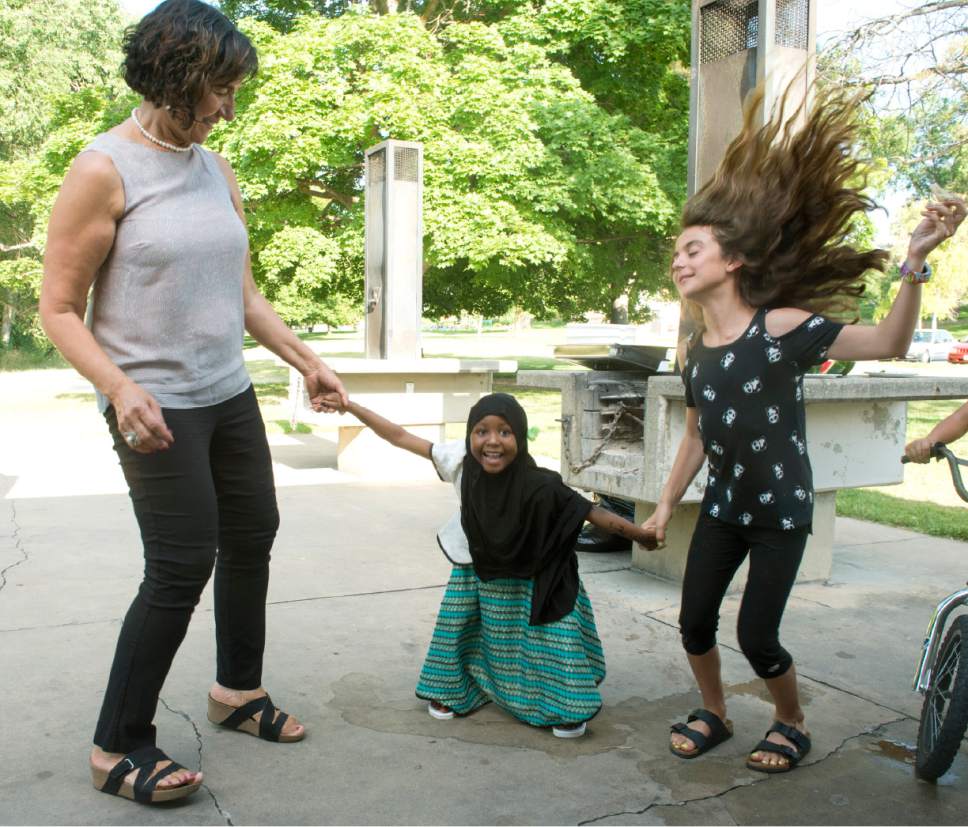 Rick Egan  |  The Salt Lake Tribune


Samira Harnish dances with 5-year-old Zenabu Addi and 10-year-old Layla Shalty at the Eid Mubarak to celebrate the end of Ramadan on Monday, June 26, 2017.
