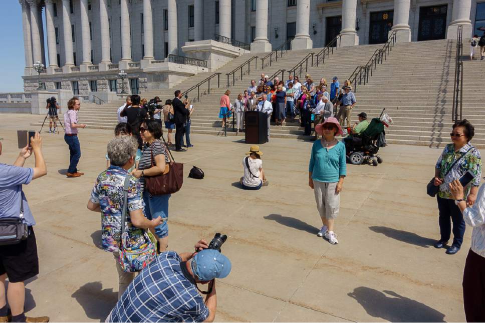 Trent Nelson  |  The Salt Lake Tribune
Tourists take photographs in front of a news conference in Salt Lake City Tuesday June 27, 2017, announcing the filing of a lawsuit challenging the 2016 law establishing partisan elections for the Utah State Board of Education. Senate Bill 78, "State Board of Education Candidate Selection," was sponsored by Senator Ann Milner and will go into effect for state school board races starting in 2018.