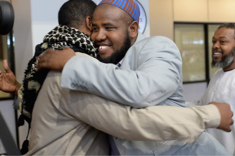 Scott Sommerdorf | The Salt Lake Tribune
Imam Yussuf Awadir Abdi gets hugs from friends after he arrived at Salt Lake City International airport, Sunday, June 18, 2017.