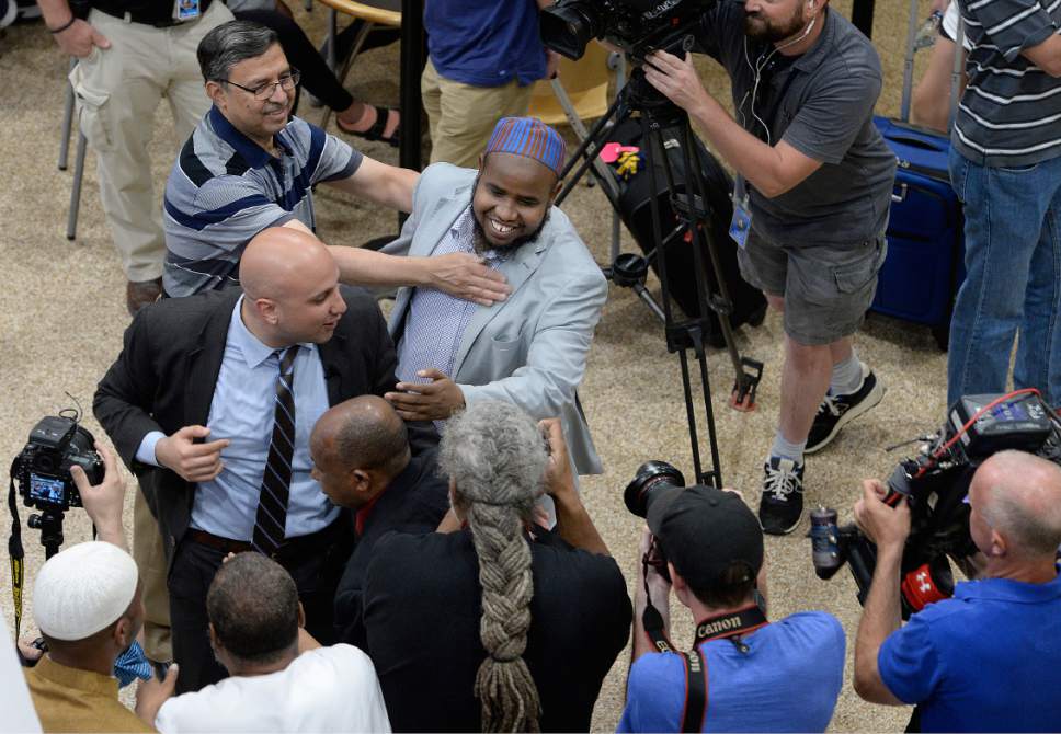 Scott Sommerdorf | The Salt Lake Tribune
Imam Yussuf Awadir Abdi gets hugs from friends and family as he arrives at Salt Lake City International airport, Sunday, June 18, 2017.