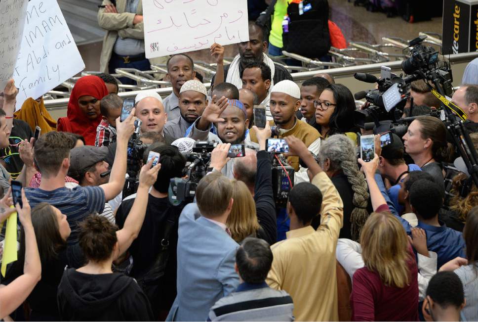 Scott Sommerdorf | The Salt Lake Tribune
Imam Yussuf Awadir Abdi is surrounded in a sea of friends, family, and media after he arrived at Salt Lake City International airport, Sunday, June 18, 2017.