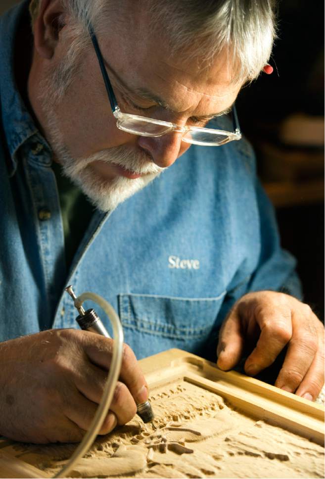 Rick Egan  |  The Salt Lake Tribune

Sculptor Steve Bartholomew works on a wood carving in the studio of his cabinet store in Cedar City. June 14, 2017.