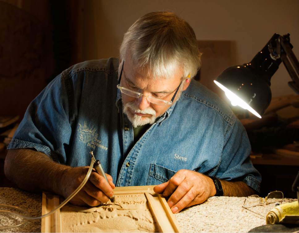 Rick Egan  |  The Salt Lake Tribune

Sculptor Steve Bartholomew works on a wood carving in the studio of his cabinet store in Cedar City. June 14, 2017.
