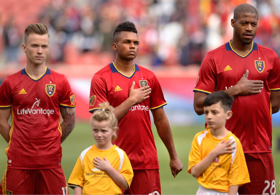 Leah Hogsten | The Salt Lake Tribune
"I don't personally feel that acknowledging issues within the country and being a proud American are mutually exclusive," said Real Salt Lake midfielder Jordan Allen, center, who places his right hand over his heart and fists his left hand, holding it out to the side during the national anthem.