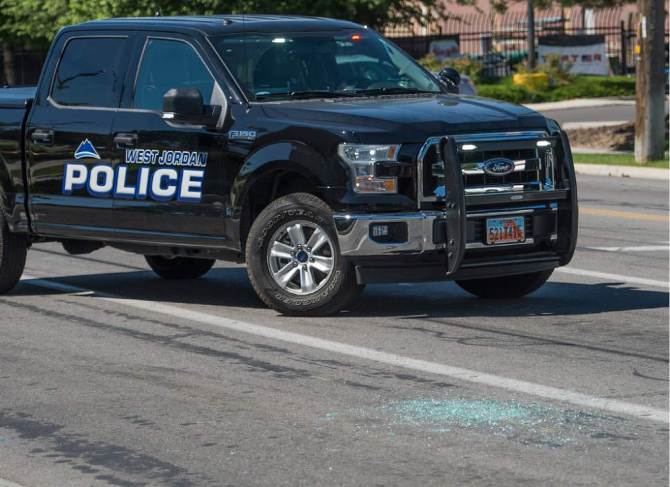 Leah Hogsten  |  The Salt Lake Tribune
Broken glass lies at the intersection of Jaguar Drive (2700 West) and 7800 South in West Jordan. West Jordan Police investigate the scene where a woman is dead after a drive-by shooting incident in West Jordan on Wednesday morning. West Jordan police Sgt. Joe Monson said the woman, whose identity was not immediately released, was stopped at a stop light at Jaguar Drive (2700 West) and 7800 South, when at least one shot was fired into her car at 8:59 a.m.. Her car crashed into a wall and a tree a short distance later.

Monson confirmed the woman was found dead at the scene.