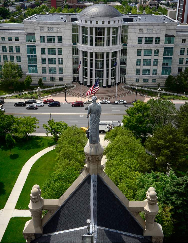 Scott Sommerdorf   |  The Salt Lake Tribune  
The statue representing "Justice" looks west toward the Scott M. Matheson Courthouse as seen from the clock tower of the City-County Building during a tour of the building, Thursday, May 26, 2016. 
City Hall is about to undergo a three-year renovation to repair stone work and do seismic upgrades. The first year will involve work on the tower and seismic improvements, followed by repairs on lower parts of the building in 2017 and 2018.