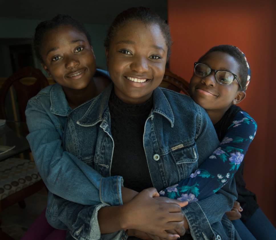 Leah Hogsten  |  The Salt Lake Tribune
 Amandine Akimana, 19, center, juggles a 40-hour-a- week job, schooling and taxi service to sisters Debra Ingabi, 16, left, and Wins Chelsea, 10, right, as well as her other two siblings to track, dance, basketball, karate and guitar class.  The East High graduate, whose family escaped the civil war in Burundi, shares legal custody of her four younger siblings with her older brother after her parents died shortly after arriving in the United States. Akimana will pursue a law degree.