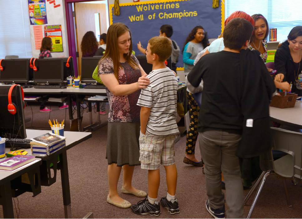 Leah Hogsten  |  The Salt Lake Tribune
Sixth-grade teacher Nichole Davis talks to one of her students in Ogden's Lincoln Elementary School in September 2015. Starting teacher salaries in Ogde will be $40,719 in the 2017-18 school year -- larger than in the surrounding Weber School District. "A lot of what the other districts have done this year, we did about three years ago without any fanfare," said Zane Woolstenhulme, business administrator in the Ogden district.