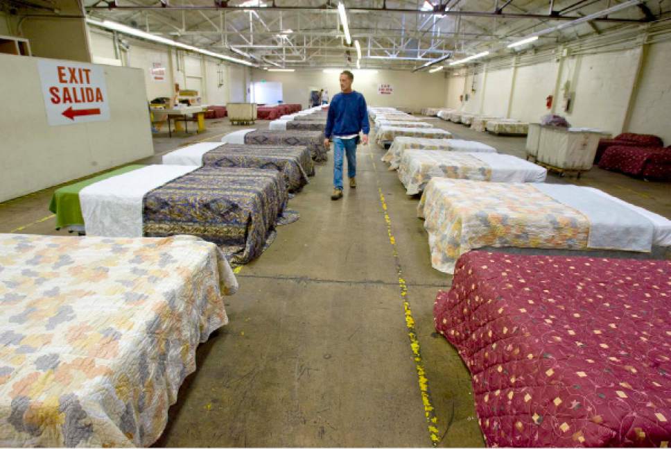 Paul Fraughton  |  Tribune file photo
Dale Griffin, lead maintenance man for the Road Home Shelter, walks down the long aisle of the overflow family shelter in Midvale in 2008. The space has 65 beds for married couples and families.