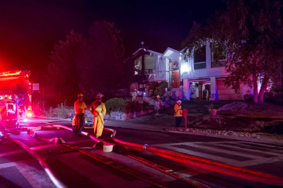 Jeremy Harmon  |  The Salt Lake Tribune


Firefighters clean up after a fire in Cottonwood Heights damaged multiple homes on Tuesday, July 4, 2017.