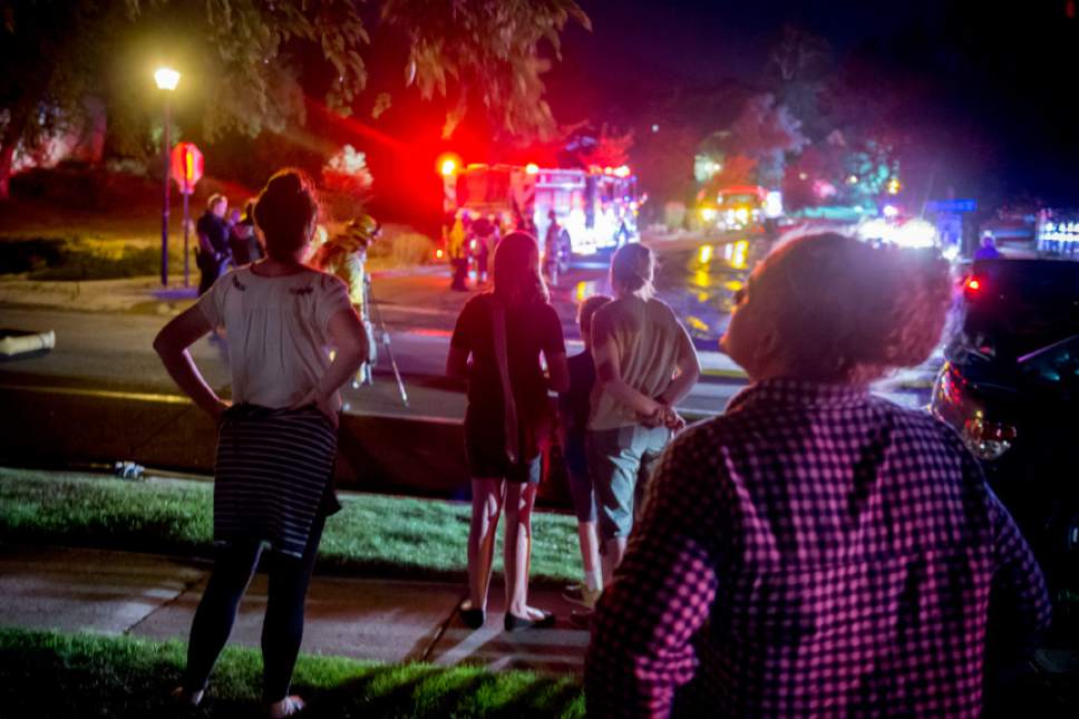 Jeremy Harmon  |  The Salt Lake Tribune


Neighbors watch as firefighters clean up following a fire in Cottonwood Heights that damaged multiple homes on July 4, 2017.