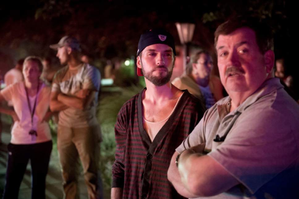 Jeremy Harmon  |  The Salt Lake Tribune
Dave Schoenbeck, center, talks to his neighbor Ron Bagley, right, as they stand across the street from Schoenbeck's fire damaged home fire in Cottonwood Heights on Tuesday, July 4, 2017. Bagley had to evacuate his house as flames approached the neighborhood earlier.