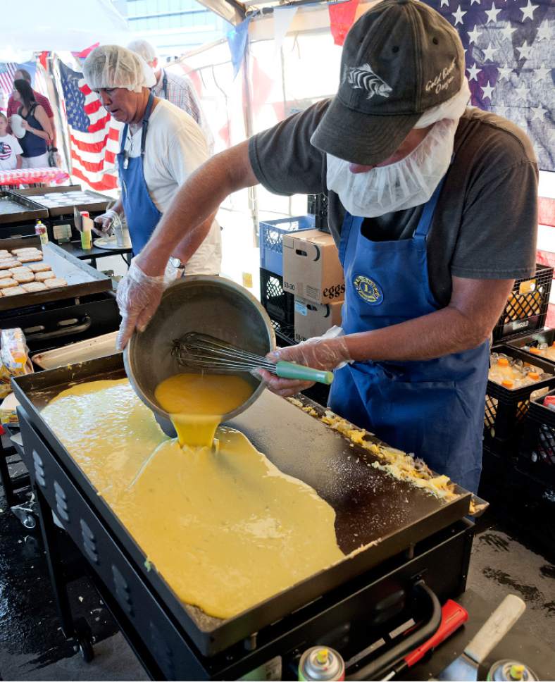 Michael Mangum  |  Special to the Tribune

Ken Shelley mans the griddle cooking scrambled eggs for the chuckwagon breakfast during an Independence Day celebration on Tuesday, July 4th, 2017 at Evergreen Park in Millcreek.