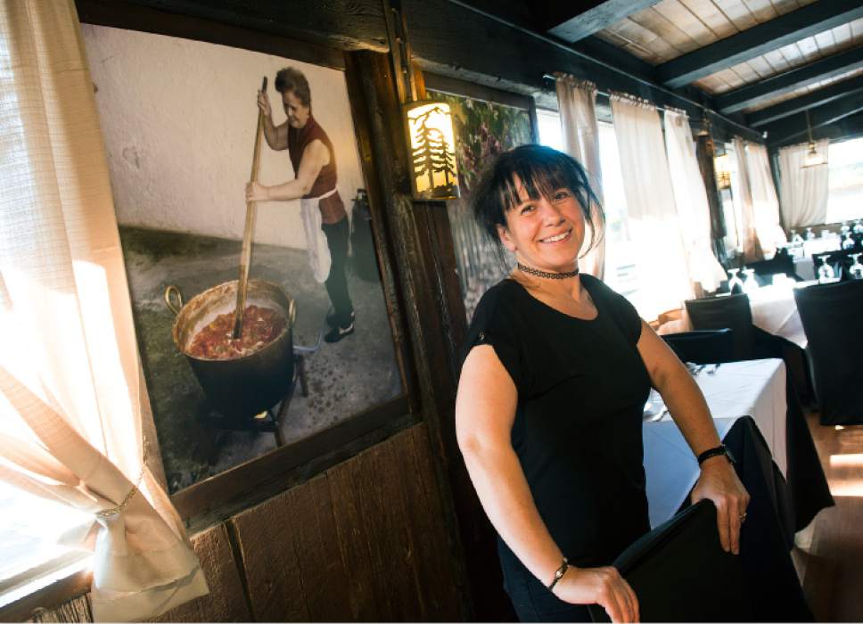 Leah Hogsten  |  The Salt Lake Tribune
Margherita D'Alessandro stands next to a photograph of her mother Fina Ventimiglia, taken over 30 years ago as she makes sauce at her home in Palermo, Sicily. The photo is on display at the entryway of Antica Sicilia, a new Italian restaurant in East Millcreek. Ventimiglia is the Sicilian family's matriarch and grandmother to Antica Sicilia owner Giuseppe Mirenda, who can still be found occasionally in the restaurant's kitchen.