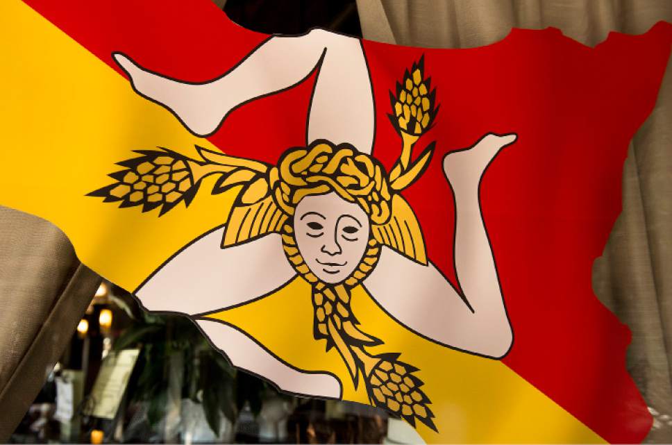 Leah Hogsten  |  The Salt Lake Tribune
The Sicilian Flag, with three bent legs, representing the three points of the triangular shape of the island of Sicily, the head of Medusa and three wheat ears adorns the window of Antica Sicilia, a new Italian restaurant in East Millcreek.
