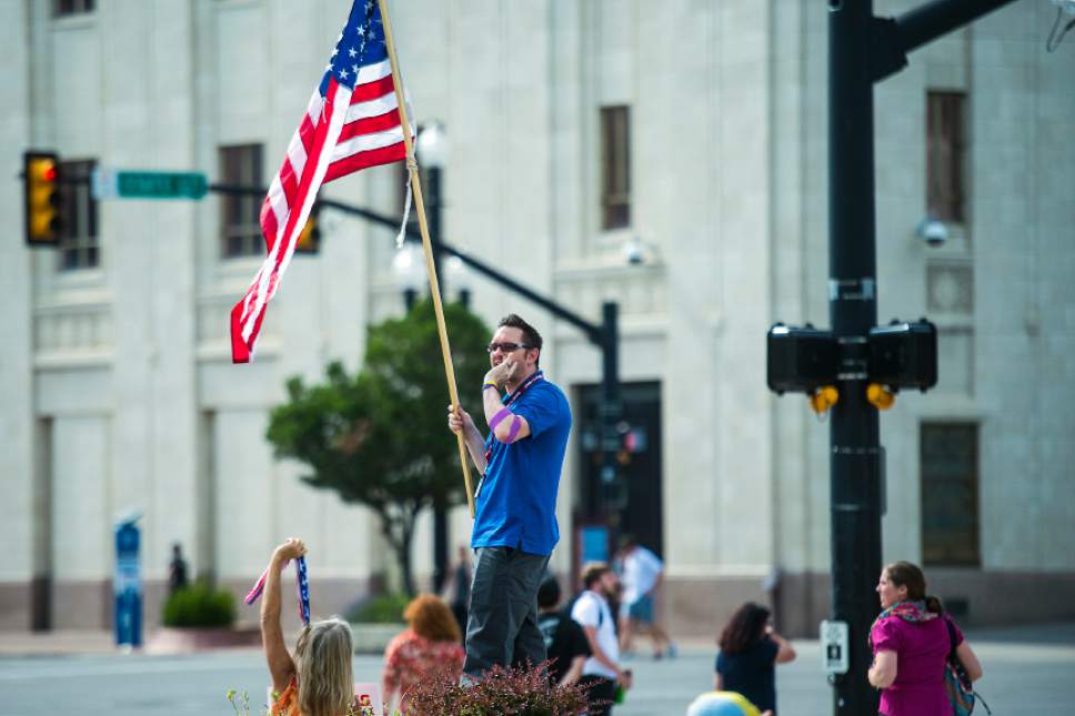 Chris Detrick  |  The Salt Lake Tribune
Joshua Cameron, who is running for Mayor of West Valley City holds and American Flag during a rally against the Better Care Reconciliation Act outside of the Wallace Bennett Federal Building Thursday, July 6, 2017.