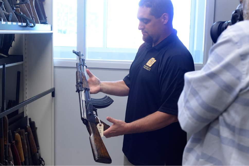 Scott Sommerdorf   |  The Salt Lake Tribune  


Senior Forensic Scientist Justin Bechaver holds an AK-47--one of the many guns stored in the gun vault at the Utah State Crime Lab in Taylorsville. Sen. Orrin Hatch, with Ed and Elizabeth Smart, toured the lab on Thursday, July 6, 2017.