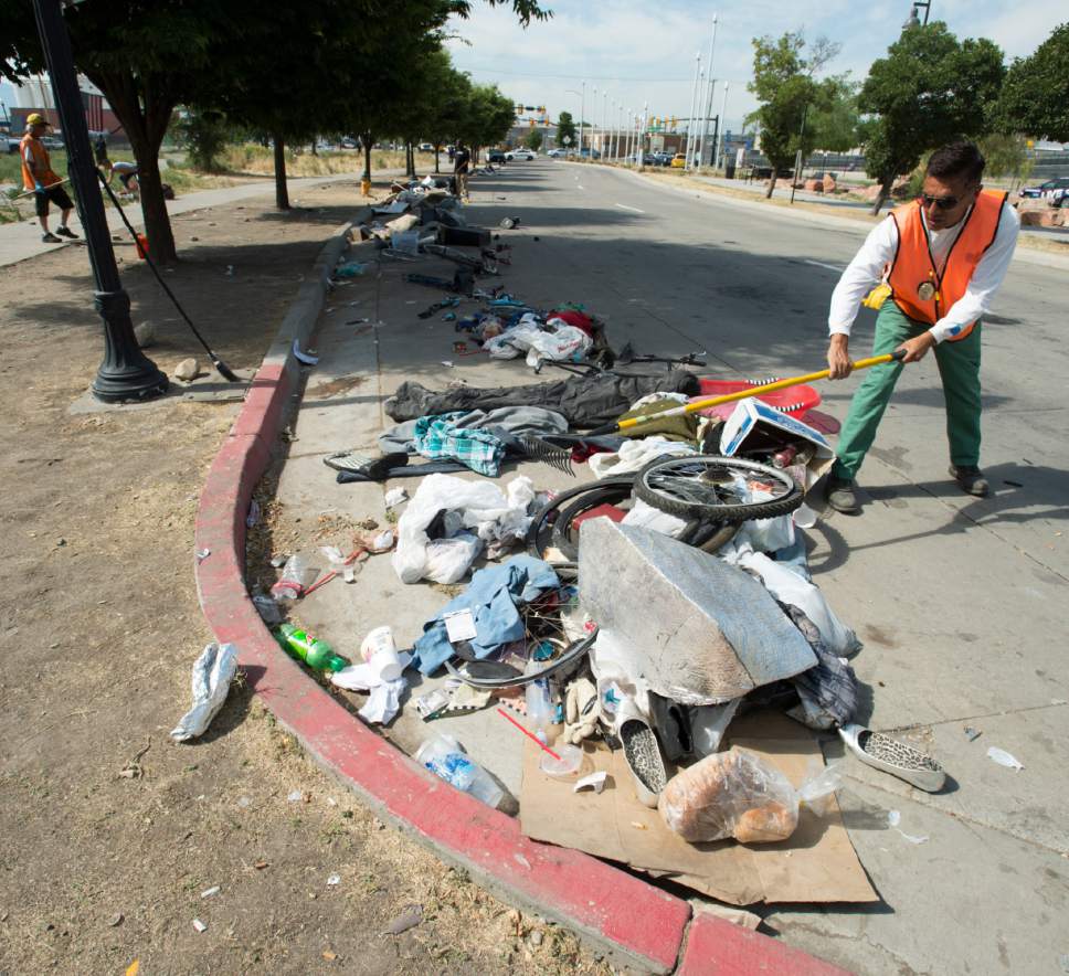 Rick Egan  |  The Salt Lake Tribune

Jorge Mendez, of the Salt Lake County Health Department, cleans up trash left by homeless campers on 500 West in Salt Lake City on Thursday, July 6, 2017. The health department does a cleanup in the area every other week or so. The biggest challenge for crews is the disposal of syringes discarded by drug users.