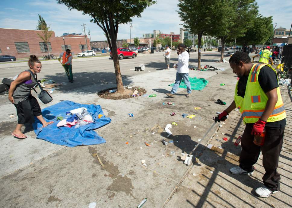 Rick Egan  |  The Salt Lake Tribune
The Salt Lake County Health Department cleans up trash left by homeless campers on 500 West in Salt Lake City on Thursday. The health department does a cleanup in the area about every other week. The biggest challenge for crews is the disposal of syringes discarded by drug users.