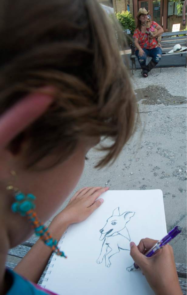 Rick Egan  |  The Salt Lake Tribune

Indy DeBirk, 11, draws a portrait of Zeke the dot, at the Millcreek Arts Festival at the  Historic Baldwin Radio Factory, Friday, July 7, 2017.
